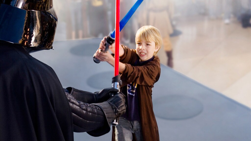 Cosplayers dressed as Darth Vader and Obi-Wan Kenobi face off with lightsabers at Star Wars Celebration.