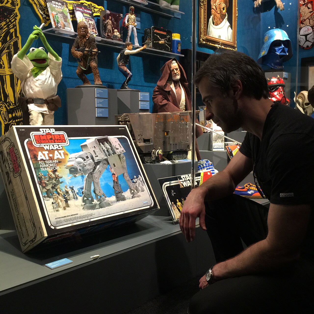 Television producer Jordan Schlansky looks at an AT-AT toy in its original packaging which is part of a display of Star Wars toys and memorabilia.