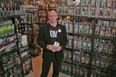 Jonathan Storey and his amazing Star Wars collection, holding his first item, a Princess Leia pencil case