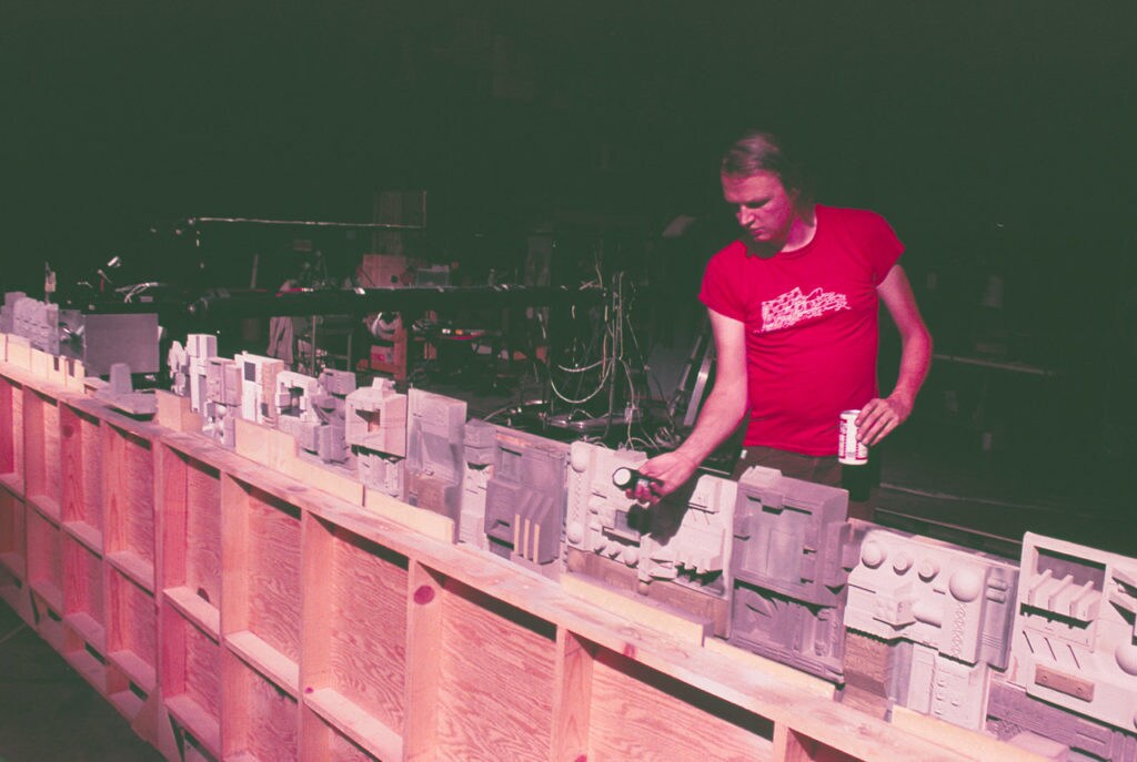 Visual effects artist Dennis Muren checks the lighting for a model Star Wars set.