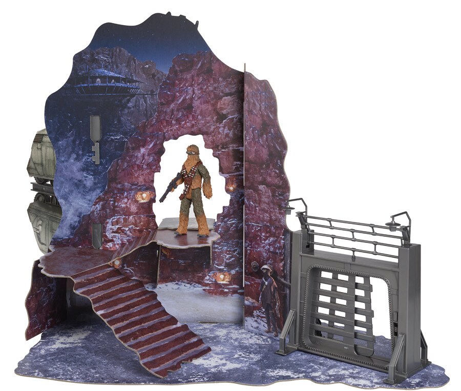 A Chewbacca Hasbro action figure with cut out of a blown out wall on the snowy planet of Vandor.