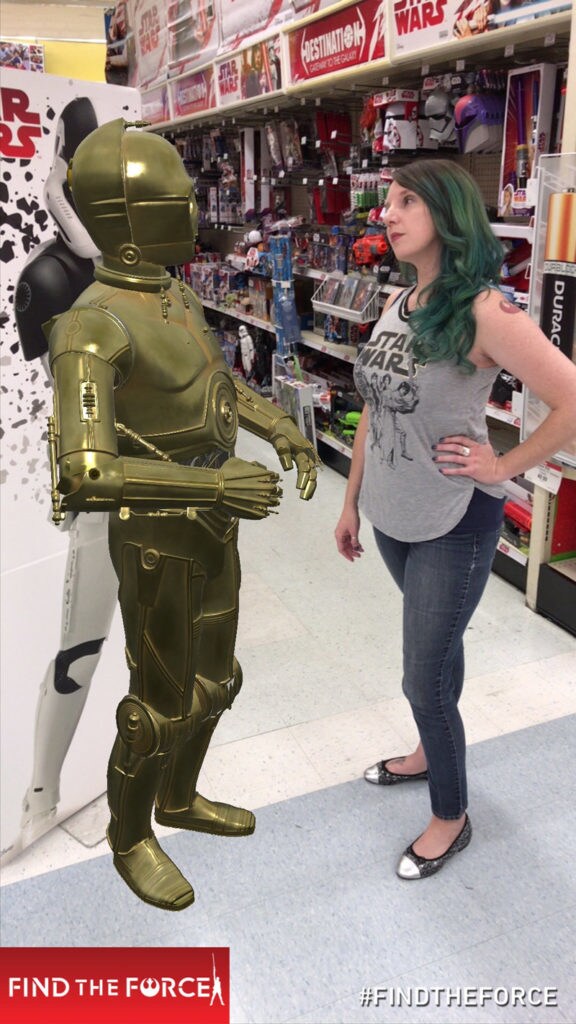 A computer generated C-3PO at Toys R Us from Find the Force, an augmented reality scavenger hunt game with game player Amy Ratcliffe.