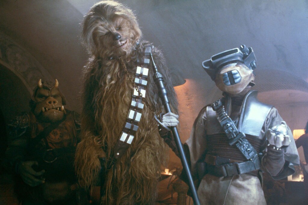 Chewbacca is escorted by Princess Leia in disguise as Boushh in Star Wars: Return of the Jedi.