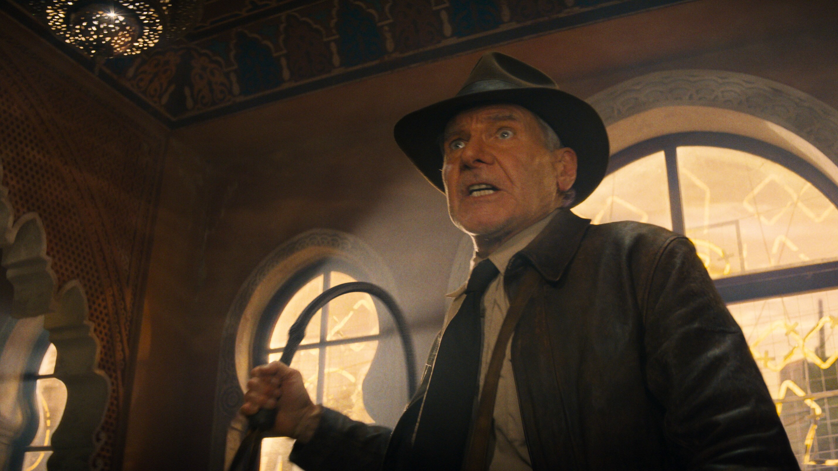 Indiana Jones holding a whip.