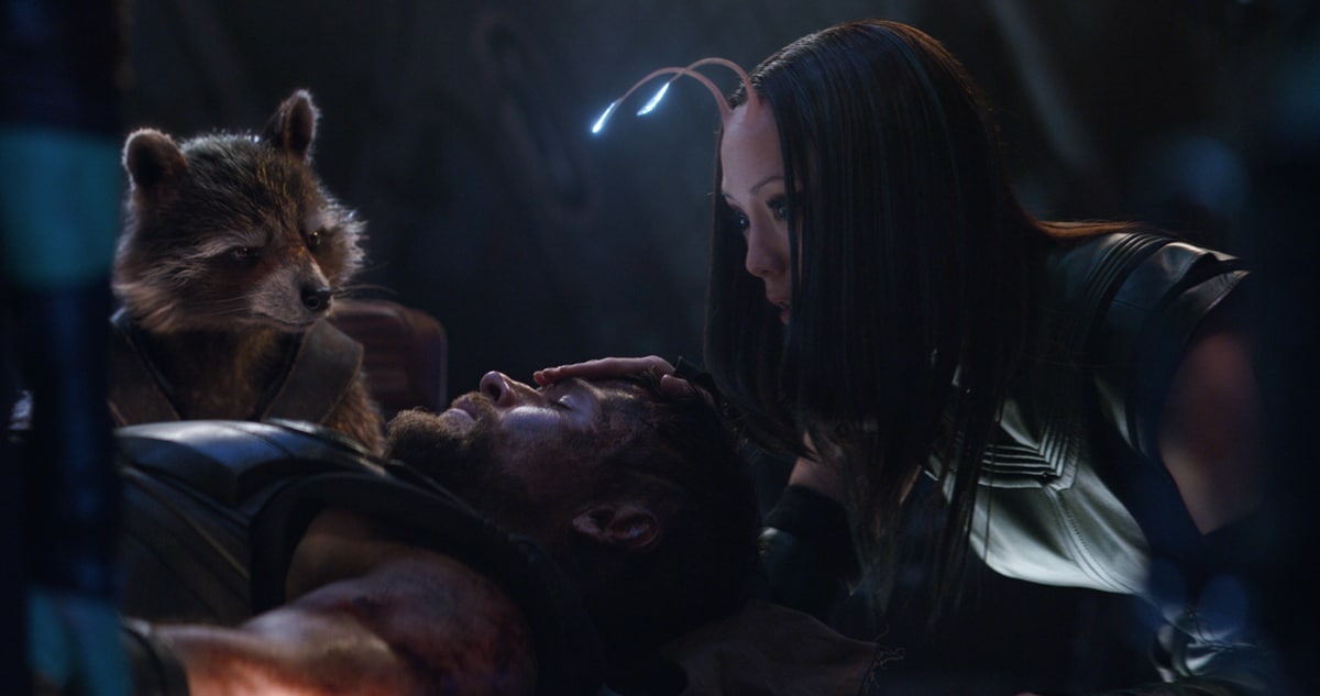 Mantis and Rocket stand over Thor in a scene from the movie Avengers: Infinity War.