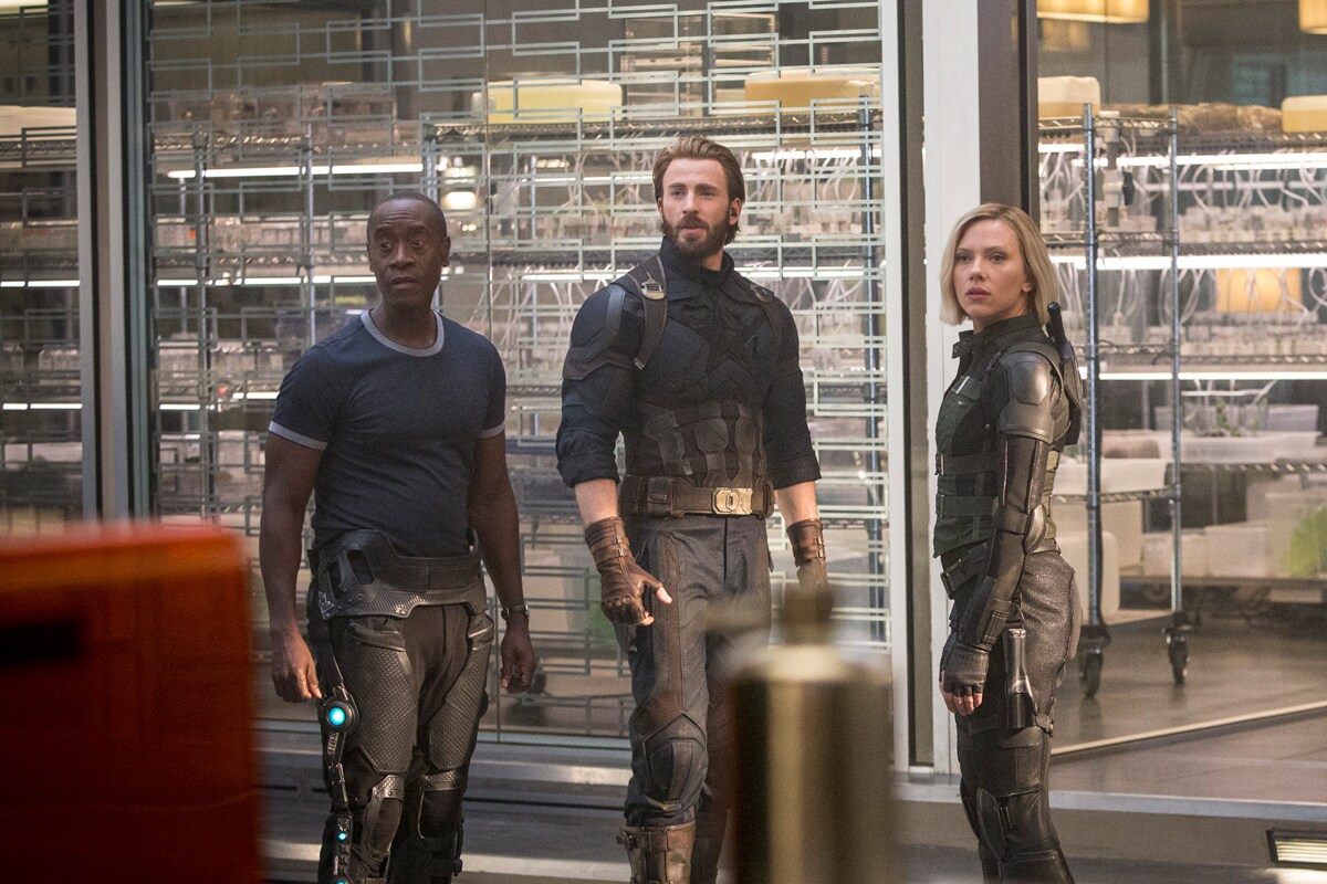 War Machine, Captain America, and Black Widow stand together in a scene from Avengers: Infinity War. 