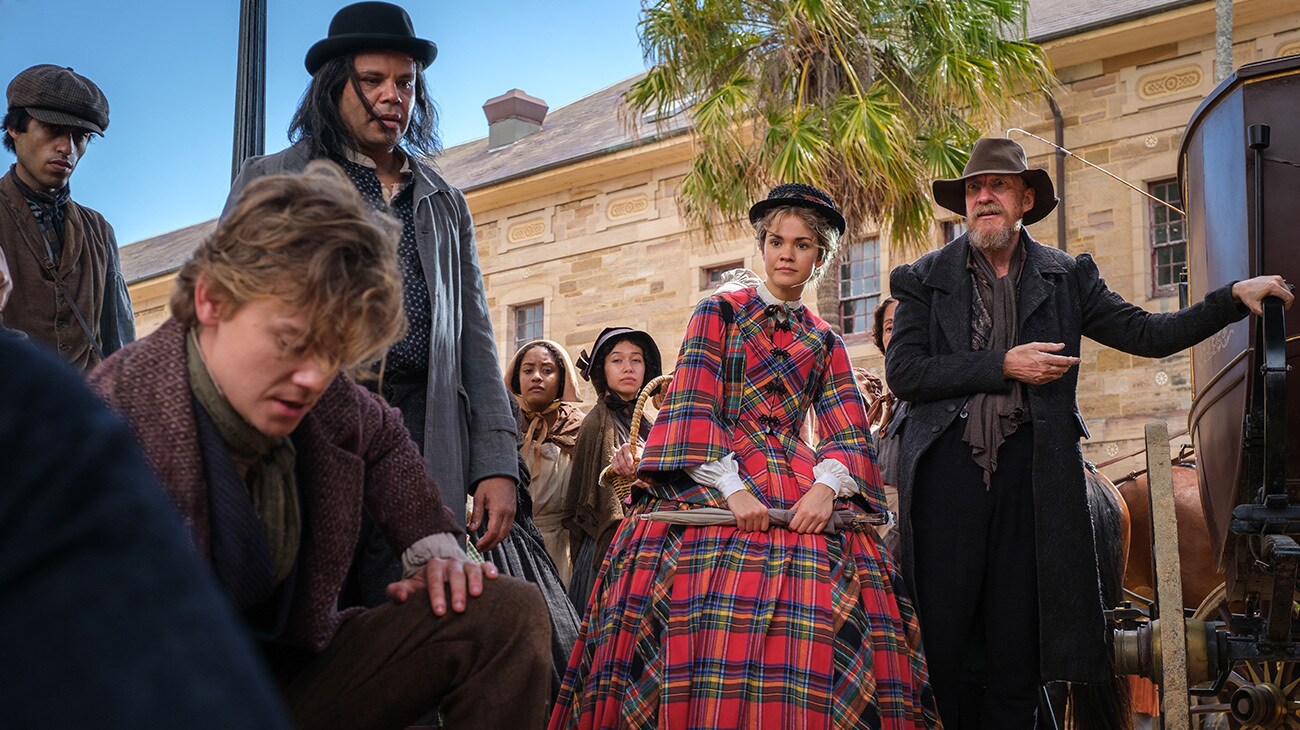 Thomas Brodie-Sangster and Maia Mitchell with supporting cast members in The Arful Dodger on Disney+