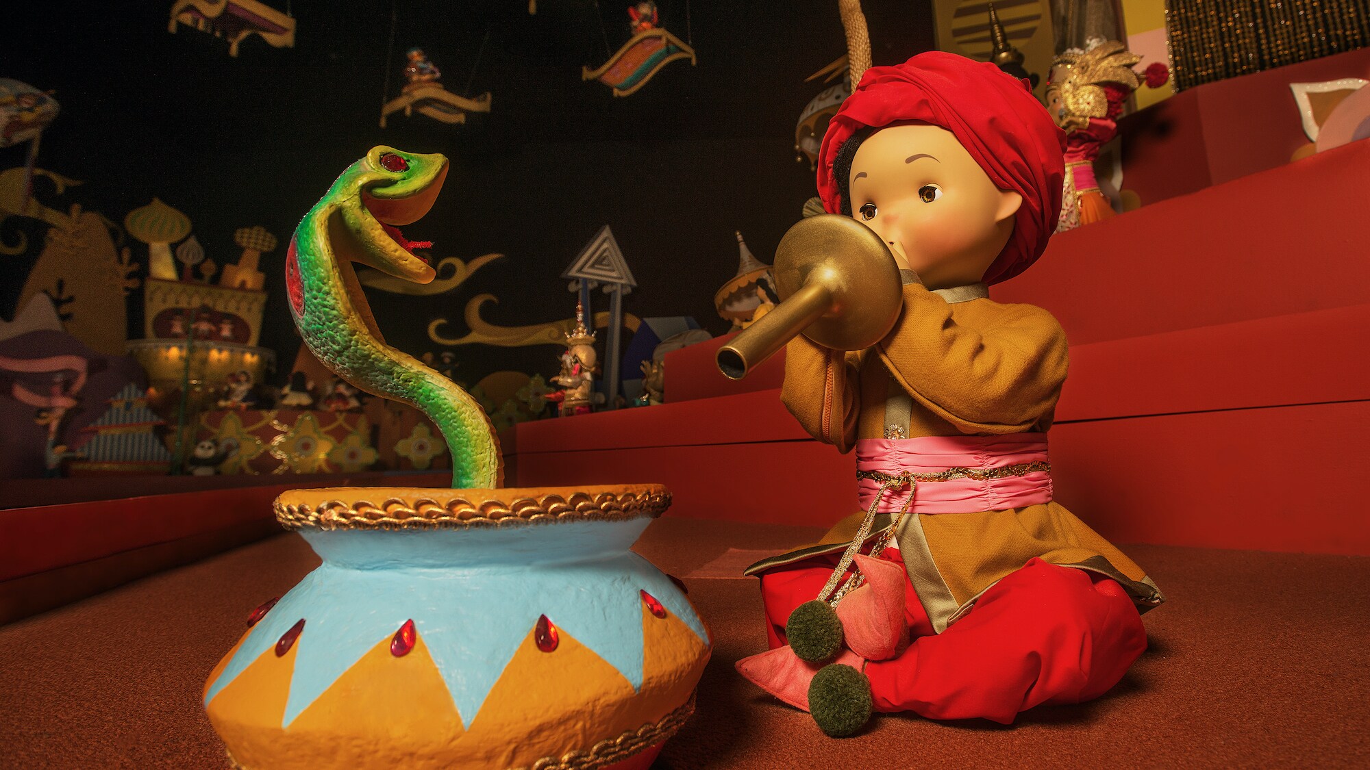 Image of a snake charmer and snake from the "it's a small world" ride.