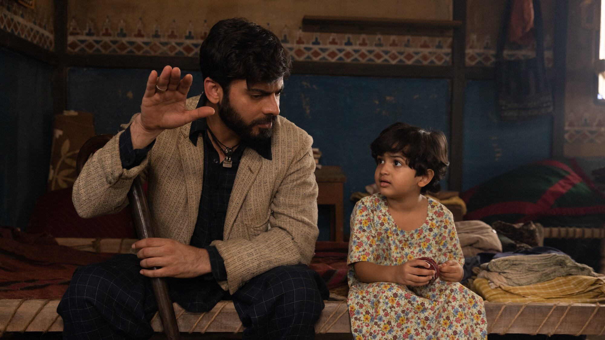 (L-R): Fawad Kahn as Hasan and Zion Usman as Young Sana in Marvel Studios' MS. MARVEL, exclusively on Disney+. Photo by Patrick Brown. ©Marvel Studios 2022. All Rights Reserved.