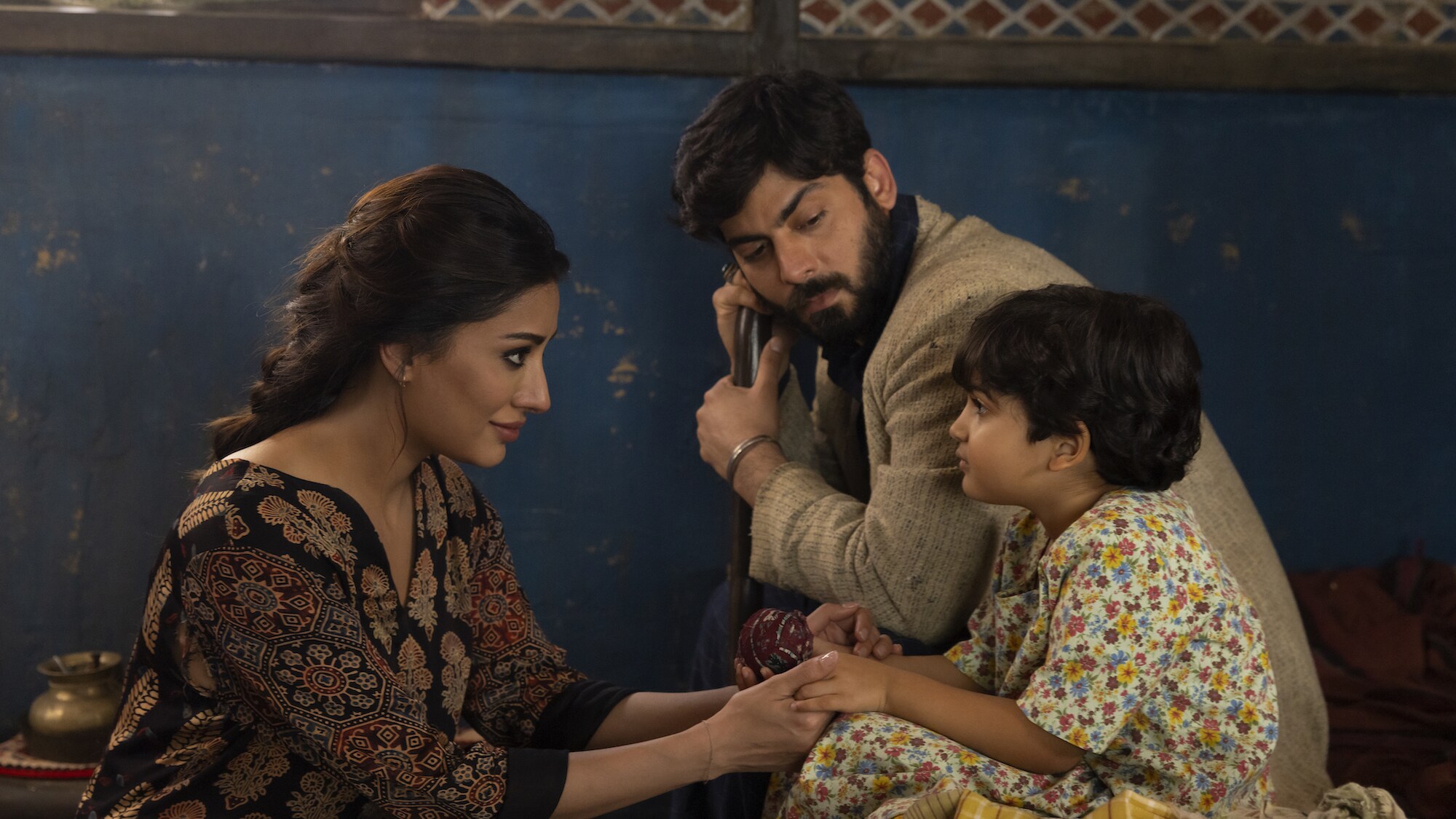 (L-R): Mehwish Hayat as Aisha, Fawad Kahn as Hasan, and Zion Usman as Young Sana in Marvel Studios' MS. MARVEL, exclusively on Disney+. Photo by Patrick Brown. ©Marvel Studios 2022. All Rights Reserved.