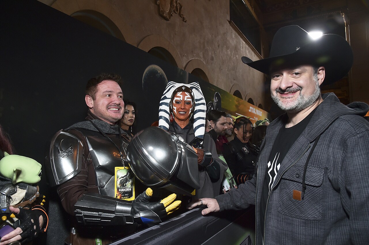 Dave Filoni signing a Mandalorian helmet