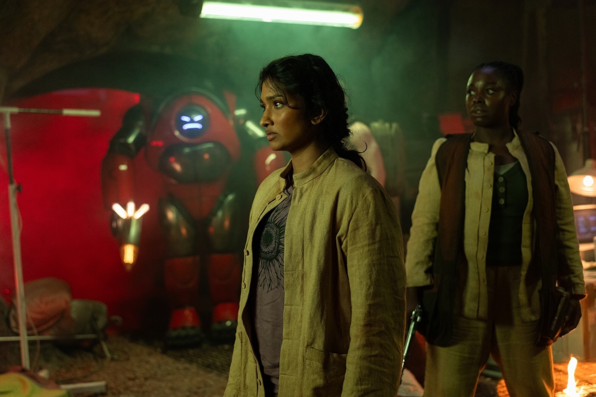 Picture Shows: Robot and Belinda Chandra (Varada Sethu) Shago (Nadine Higgin) James Pardon/BBC Studios/Disney/Bad Wolf