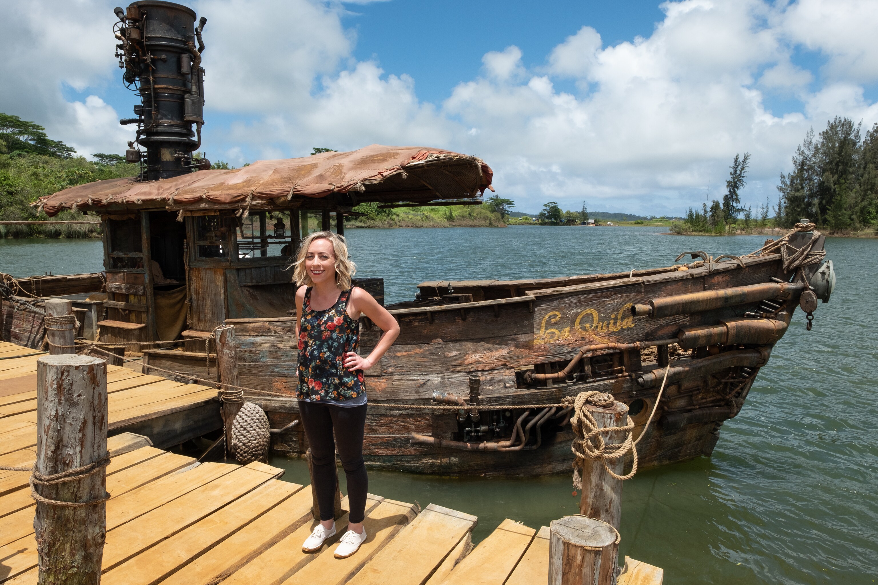 Correspondent Michelle Lema standing in front of of the docked boat La Quila on set of Disney's Jungle Cruise