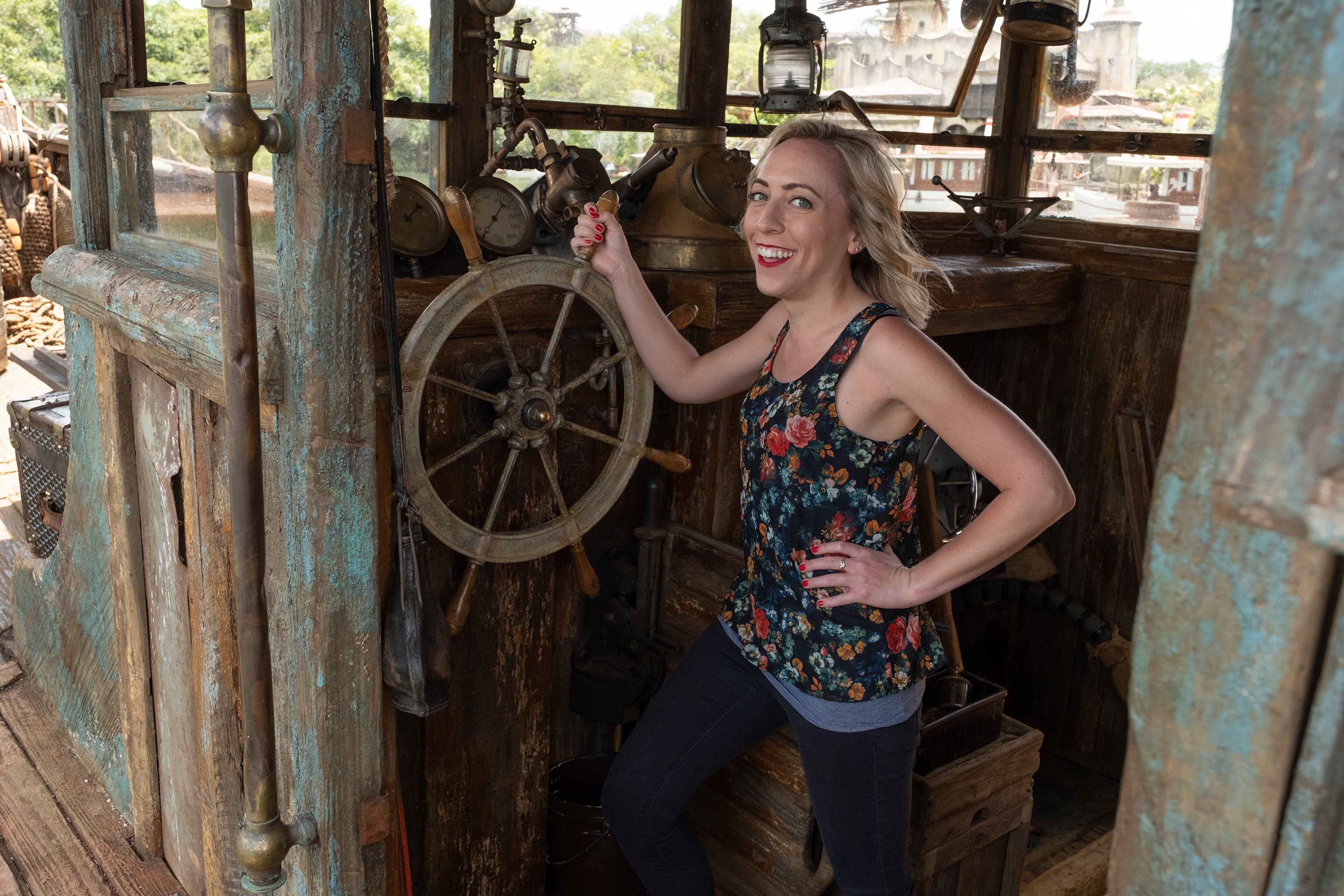 Correspondent Michelle Lema standing at the helm of the boat La Quila on the set of Disney's Jungle Cruise