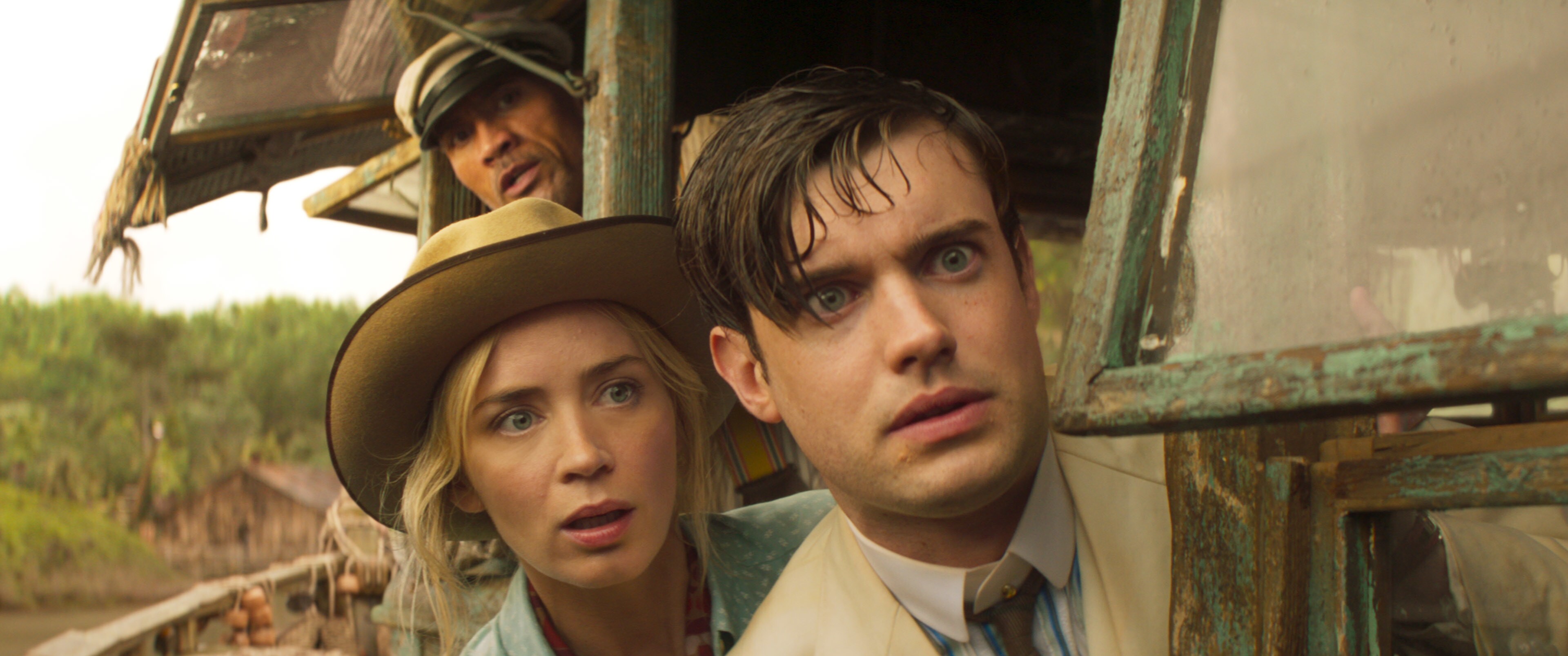 Jack Whitehall, Emily Blunt, and Dwayne Johnson on a boat in a scene from The Jungle Cruise