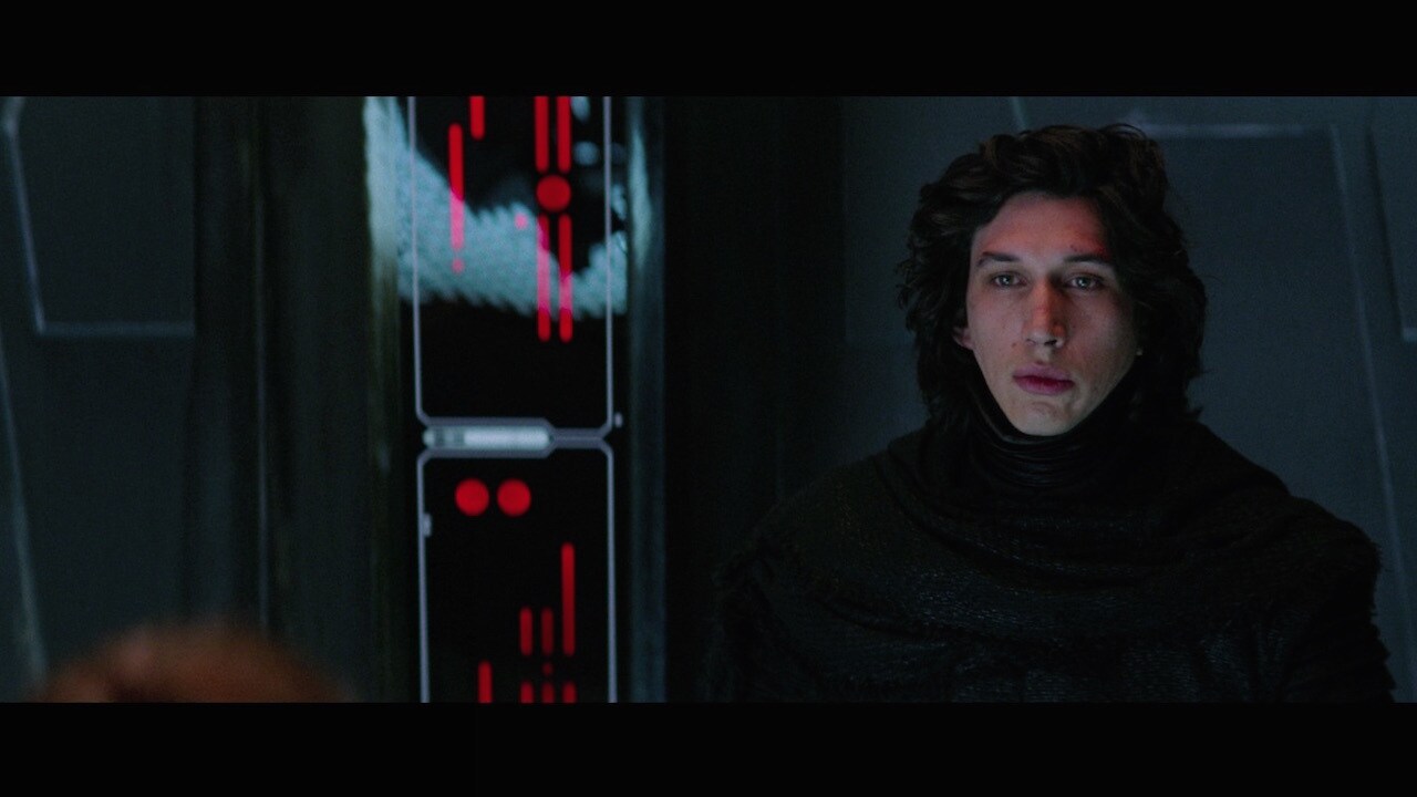 Speaking with his captive, Kylo removed his mask, revealing his surprisingly young face, and used...