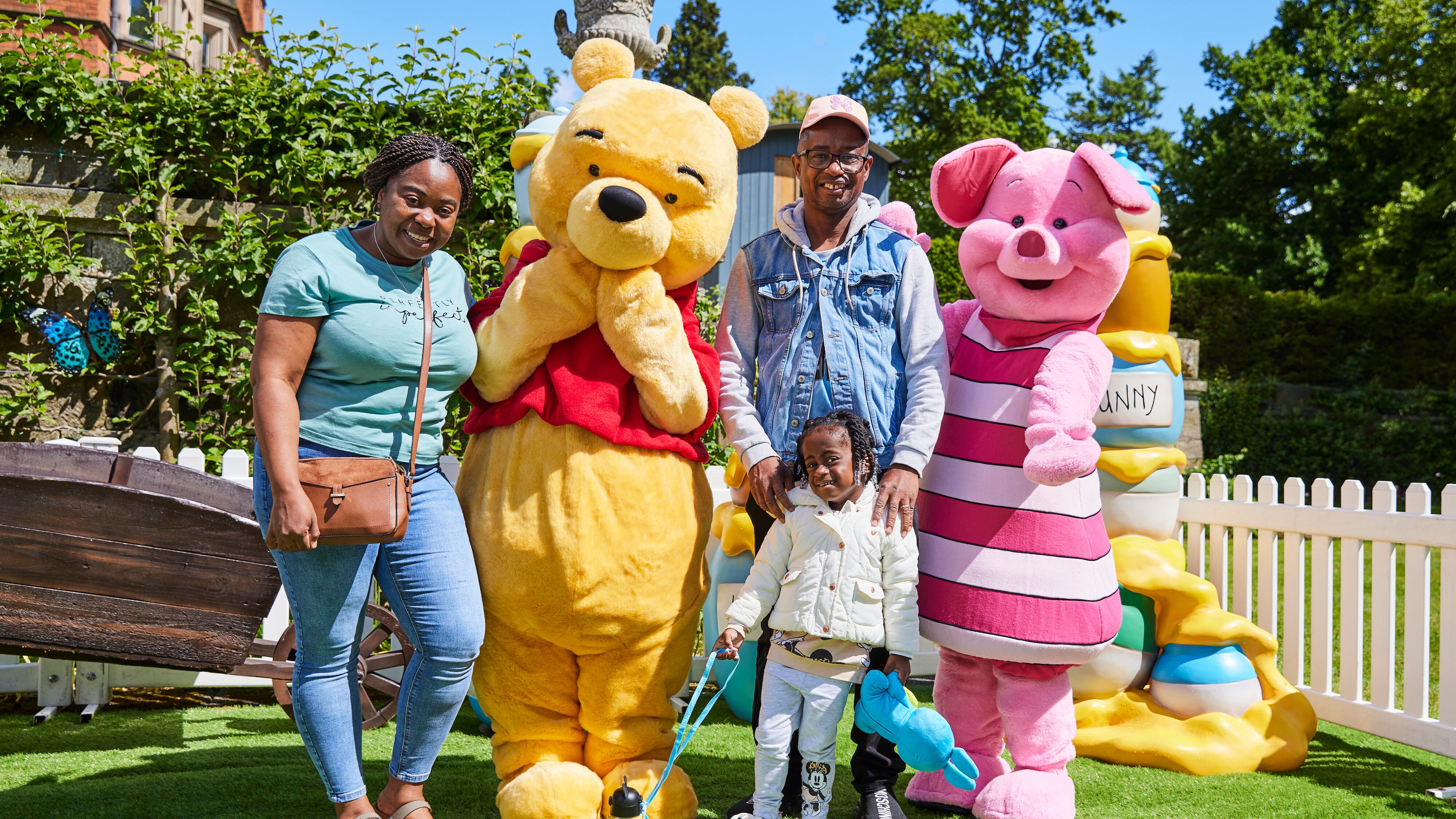 Girl and family with Winnie the Pooh and Piglet 