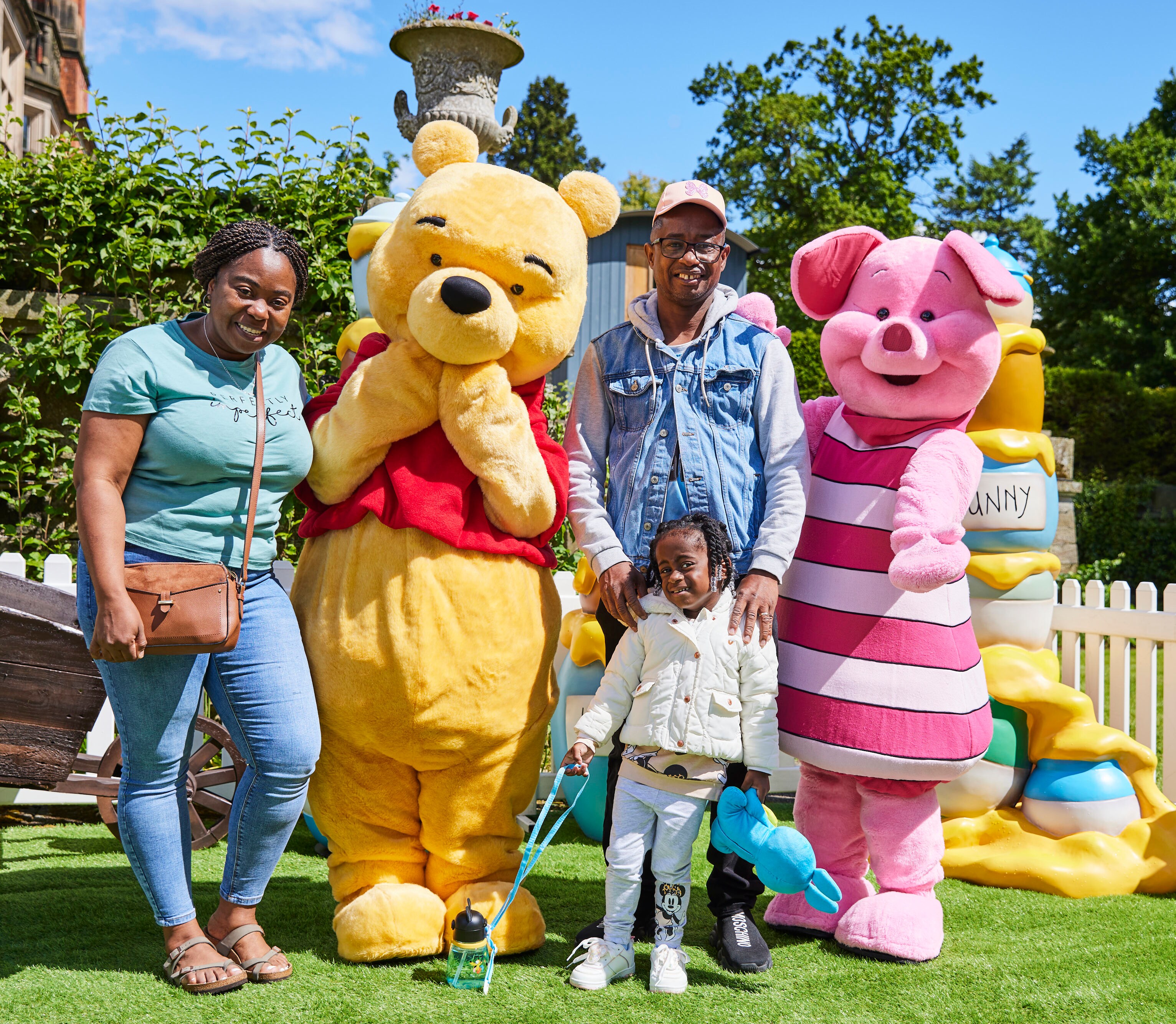 child with family with Winnie the Pooh and Piglet