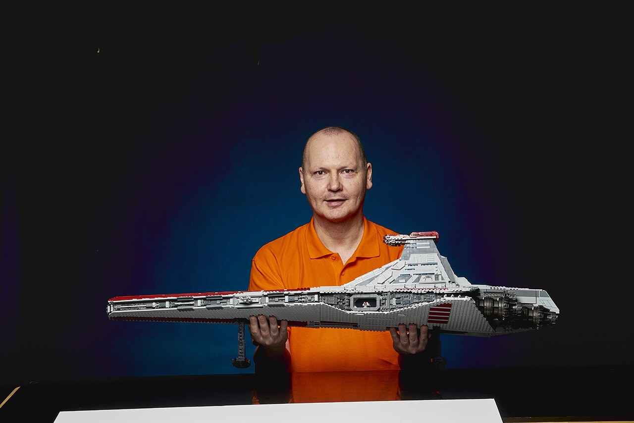 LEGO star wars designer Hans Burkhard Schlömer holding the LEGO Star Wars UCS Venator-Class Republic Attack Cruiser