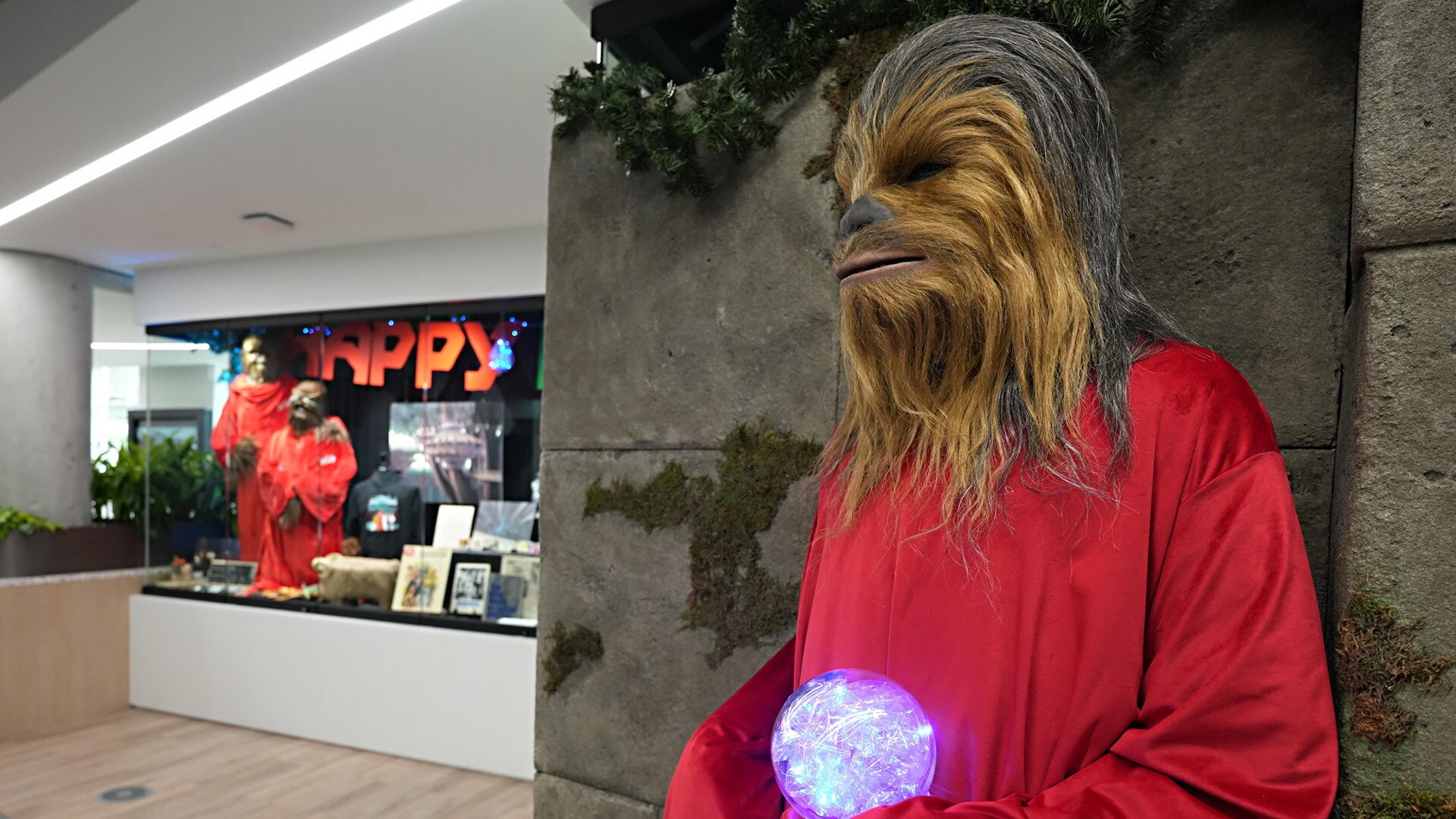 Chewbacca in front of Lucasfilm's Life Day display.