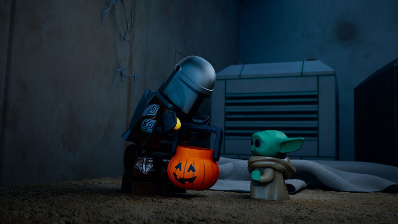 The Mandalorian and Grogu with a Halloween bucket in the LEGO Star Wars short "Mandoween."