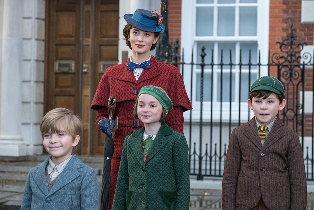 Mary Poppins with Annabel, John, and Georgie in front of the Bank's residence