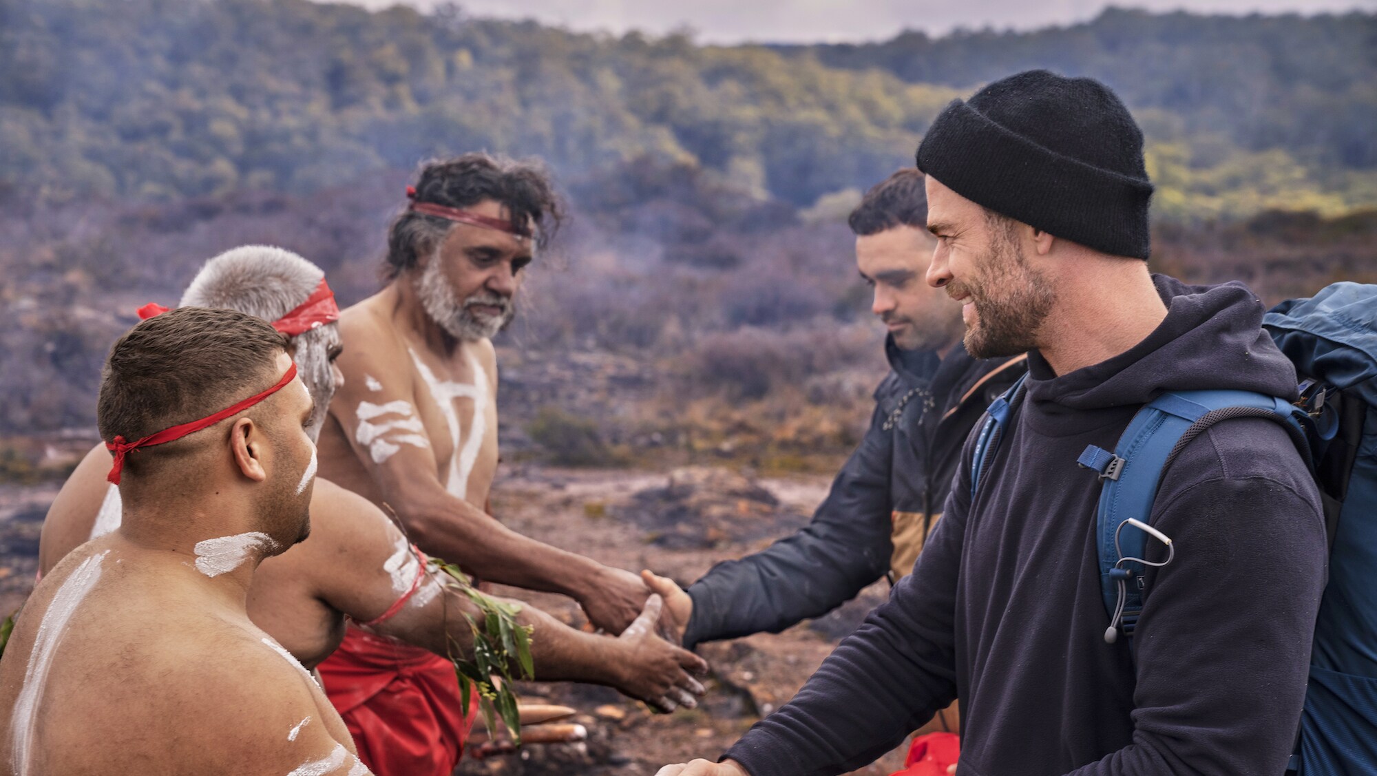 Chris Hemsworth and Otis meet the first nations tribe of Otis Carey's ancestral home. (National Geographic for Disney+/Craig Parry)