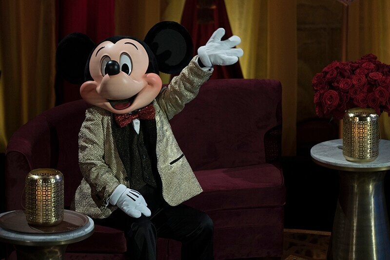 Mickey in gold suit jacket and shimmering red bow tie