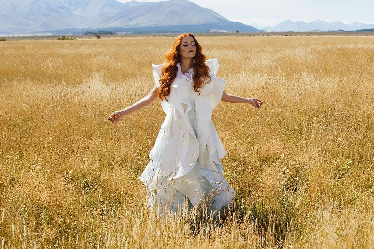 Reese Witherspoon in a field in the movie "A Wrinkle in Time"