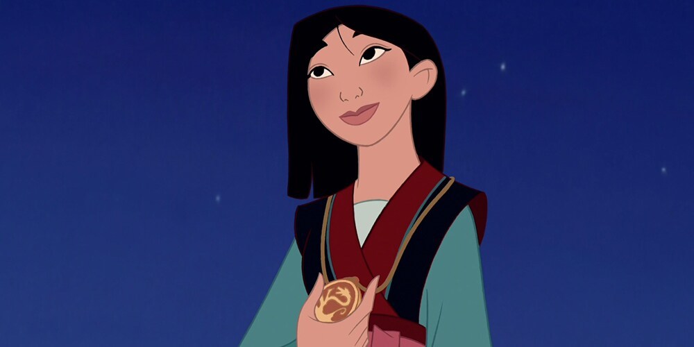 Mulan holding a gold medal around her neck in the animated movie "Mulan"