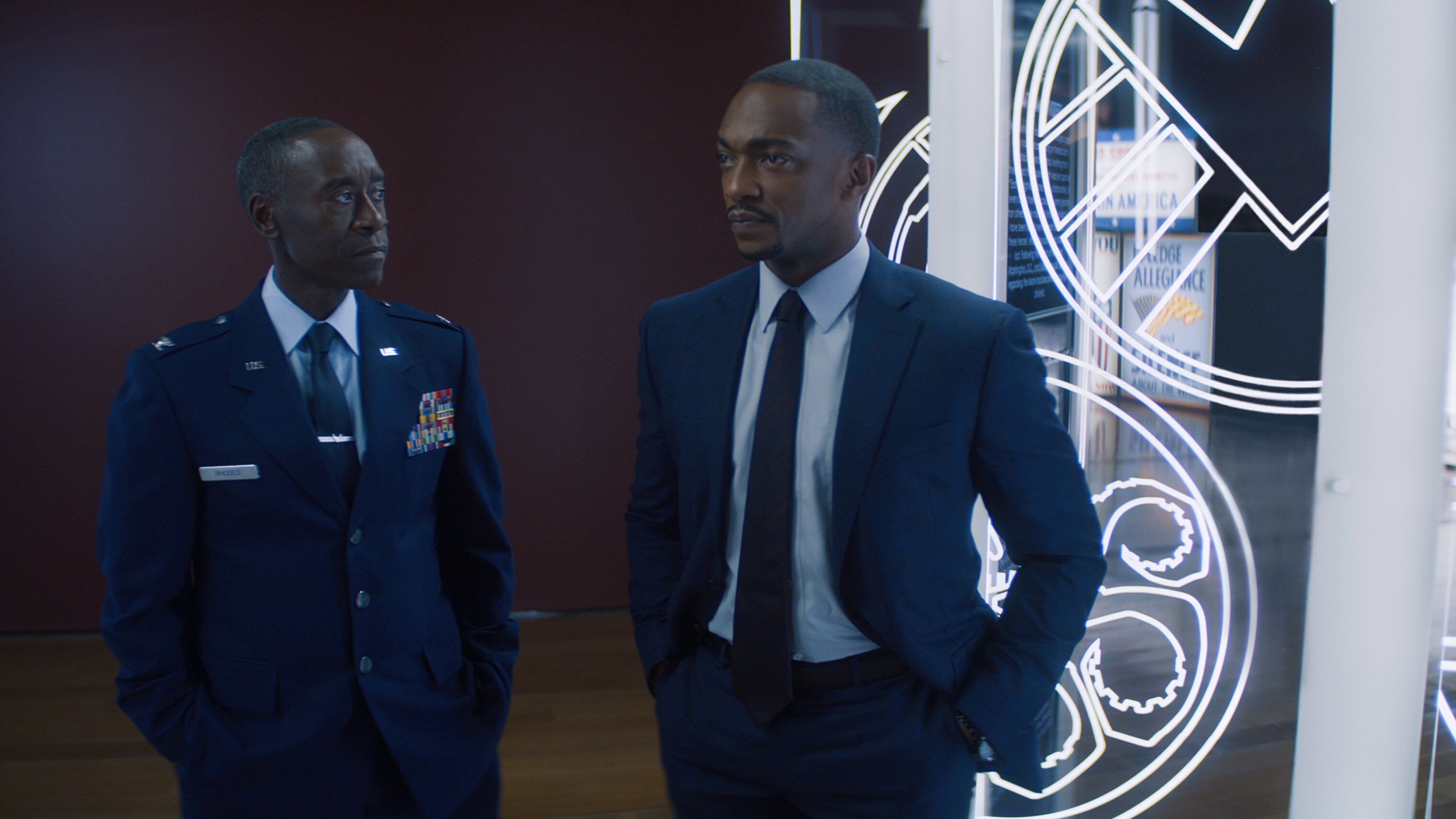 (L-R): Rhodey (Don Cheadle) and Falcon/Sam Wilson (Anthony Mackie)  in Marvel Studios' THE FALCON AND THE WINTER SOLDIER exclusively on Disney+. Photo courtesy of Marvel Studios. ©Marvel Studios 2021. All Rights Reserved.