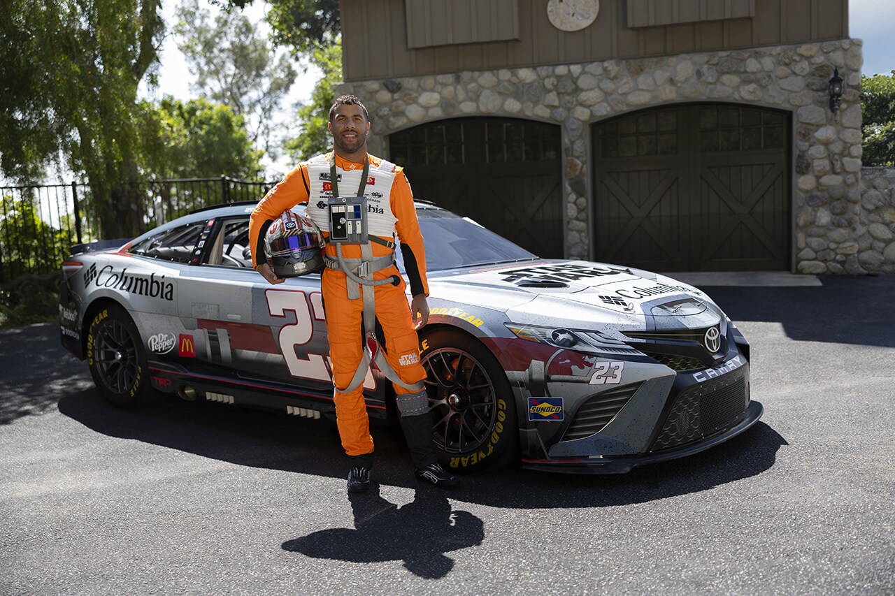 Bubba Wallace in front of the X-wing wrapped car.