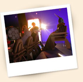Within the barren set, Ian McDiarmid sits as Palpatine, awaiting a guest, along with his aides Sly Moore and Mas Amedda and a pair of red robed guards.