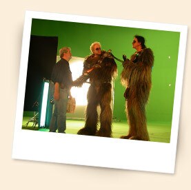 George Lucas with Wookiees behind the scenes of Episode III.