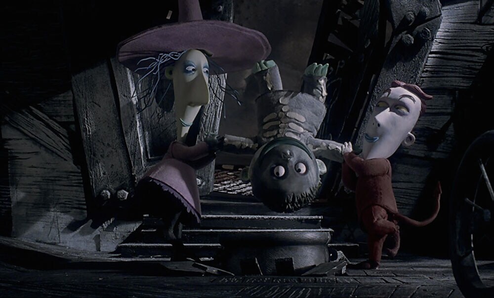 Lock and Shock holding Barrel upside down in the film "The Nightmare Before Christmas"