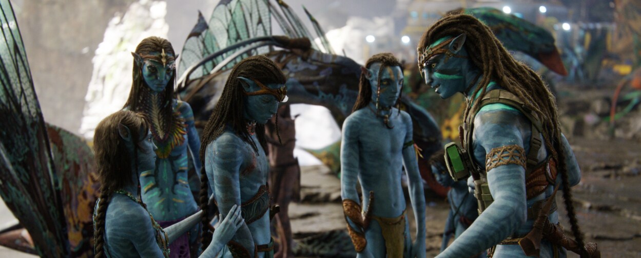 The Sully family stands together, talking forlornly.