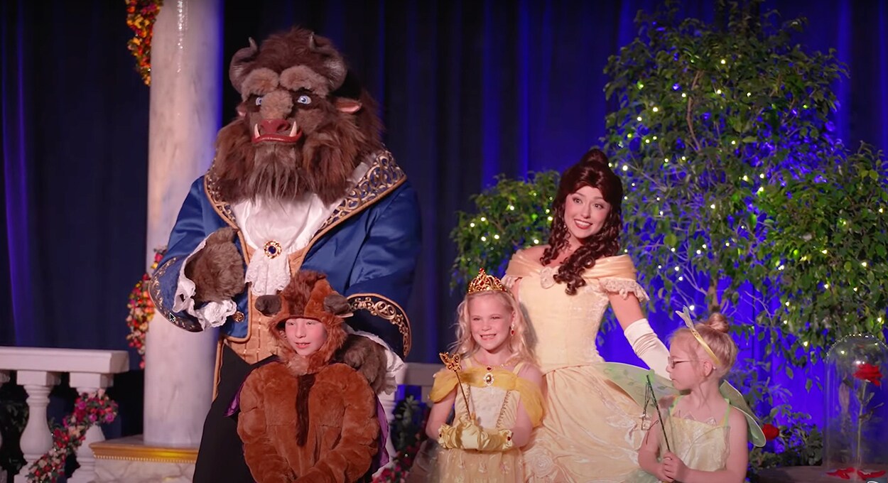 Beast and Belle characters pose with three kids.