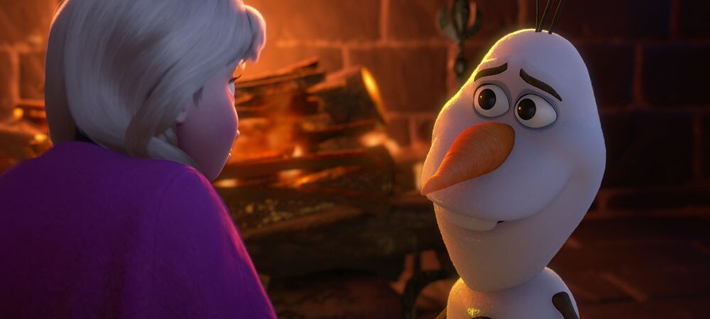 Animated characters Anna and Olaf sitting infront of a fireplace from the movie "Frozen"