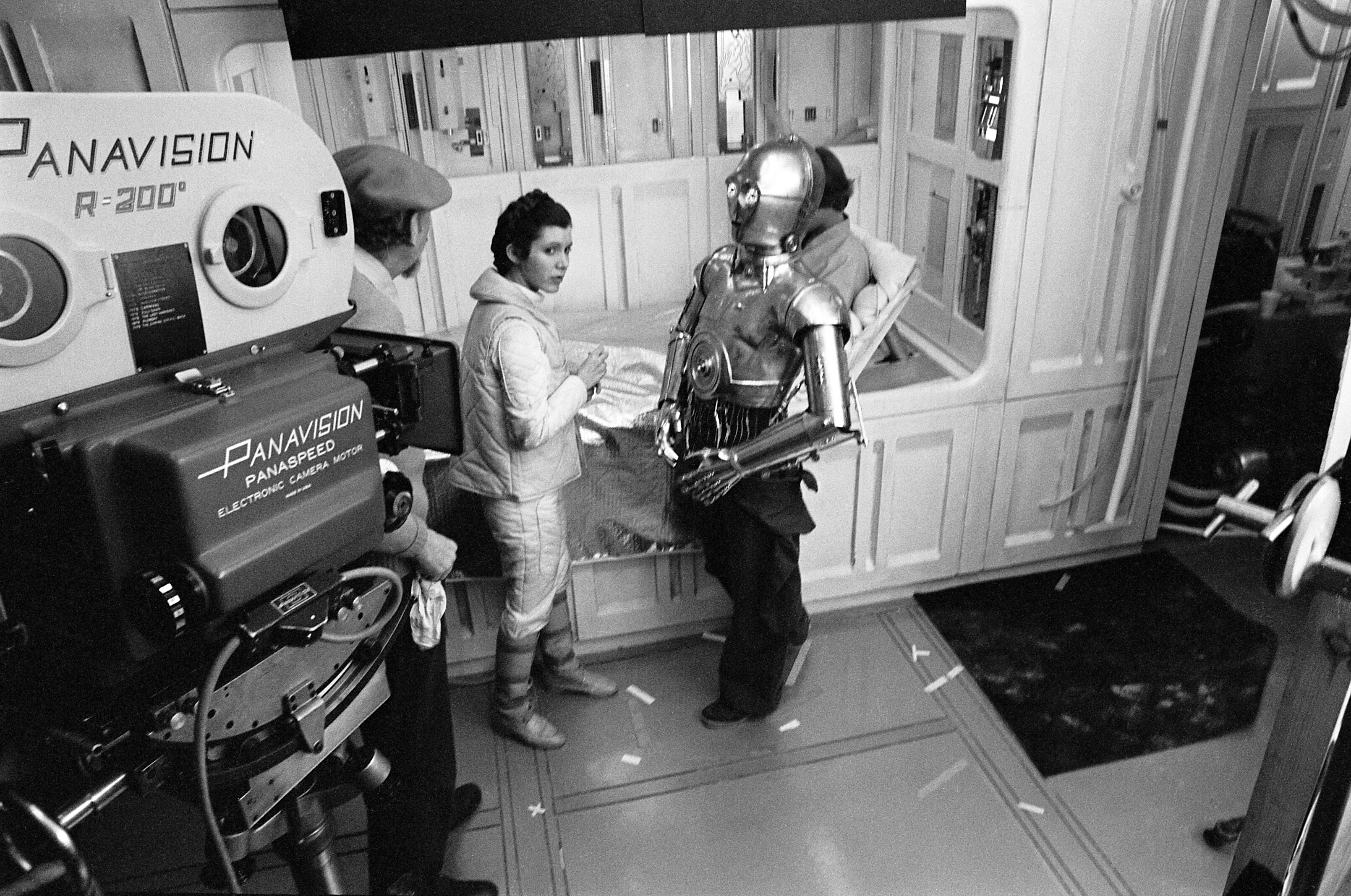 Irvin Kershner talks with Carrie Fisher, Anthony Daniels, and Mark Hamill.