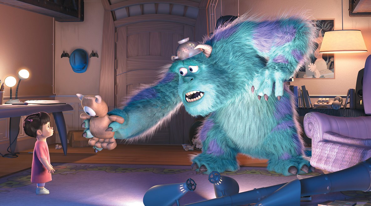 Sulley, played by John Goodman, showing Boo a stuffed teddy bear in a living room