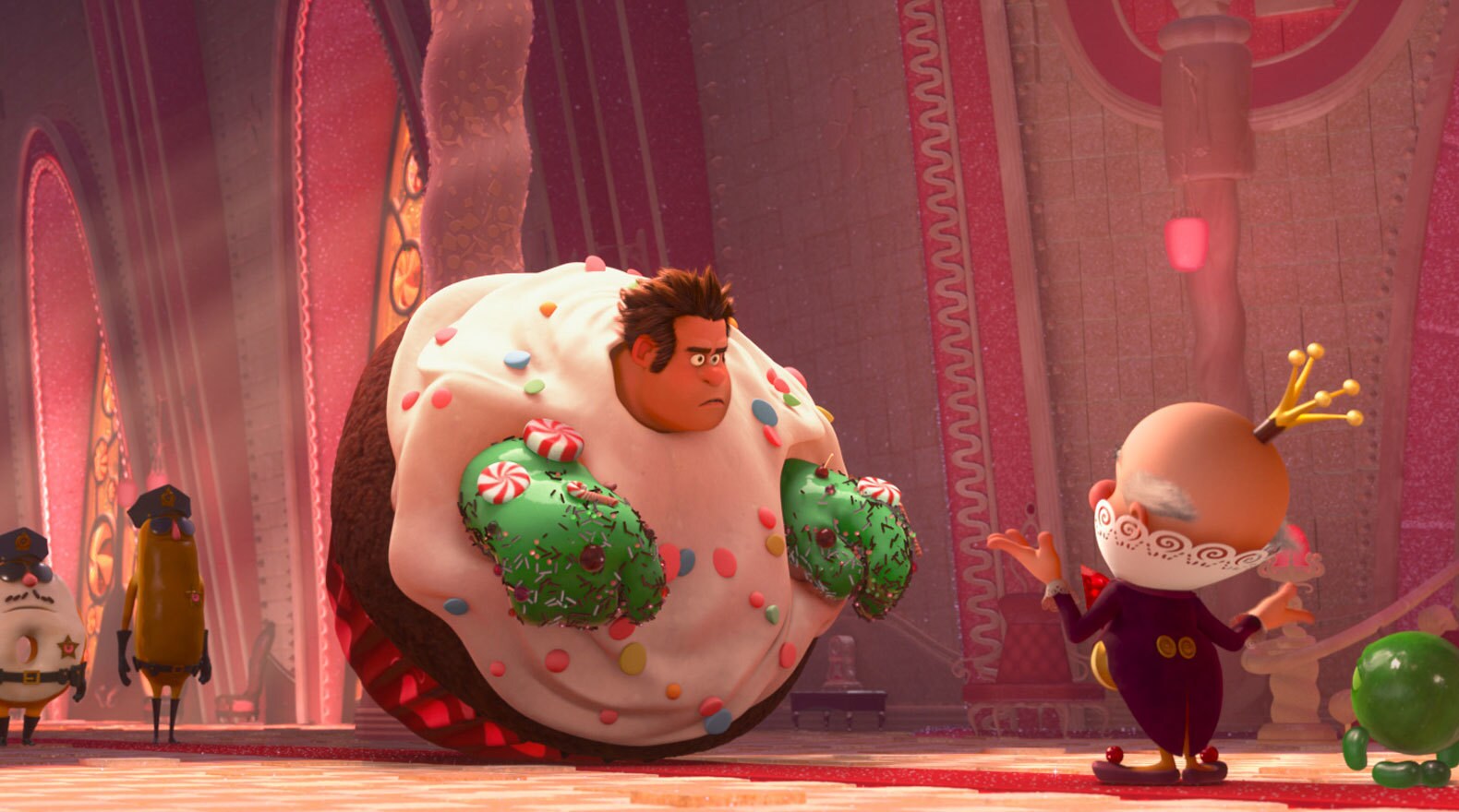 King Candy talking to Ralph, played by John C. Riley, who is stuck in a giant cupcake with green hands in "Wreck-It Ralph"