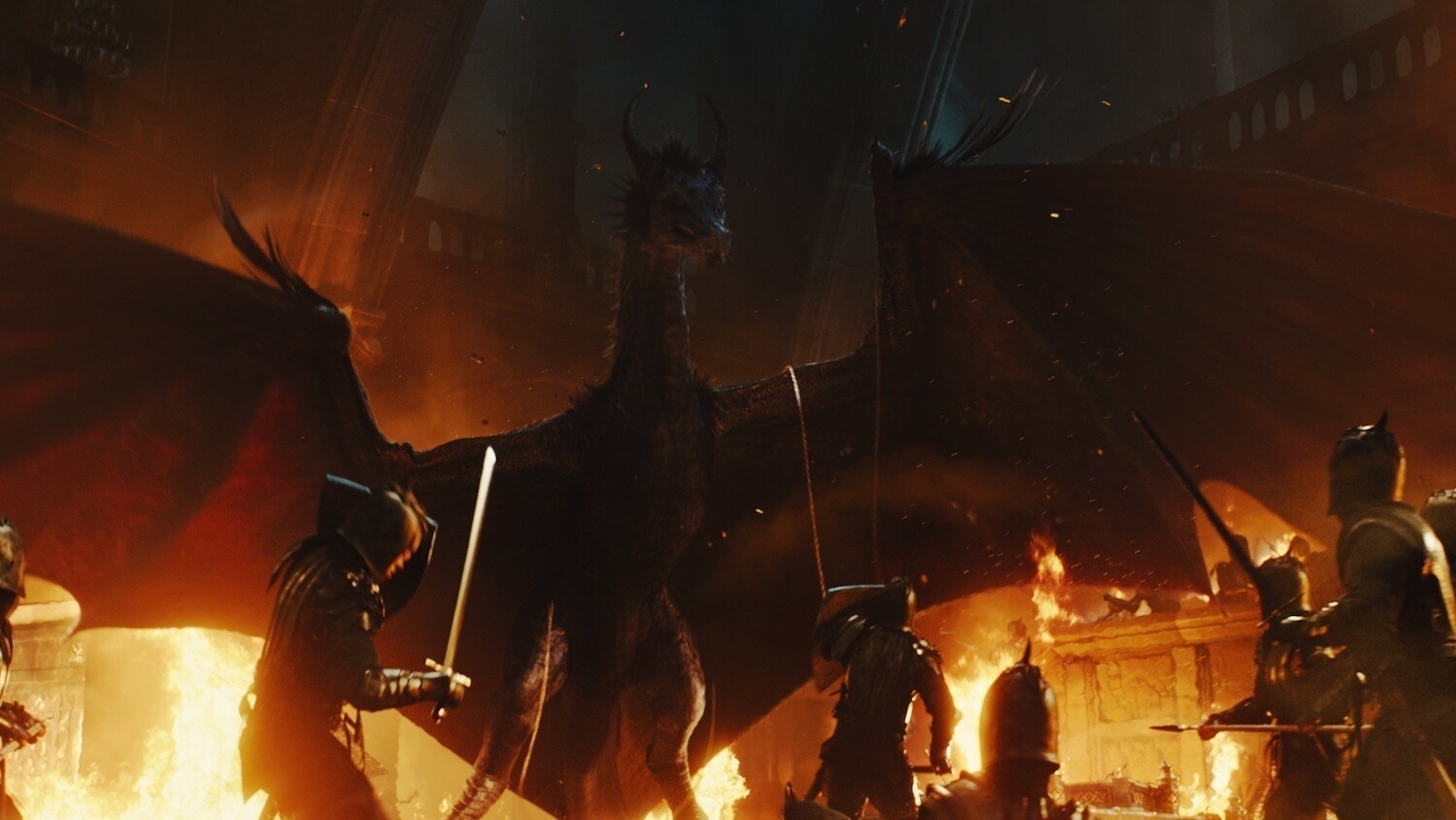 Maleficent as a dragon, surrounded by soldiers and fire, in the movie "Maleficent"