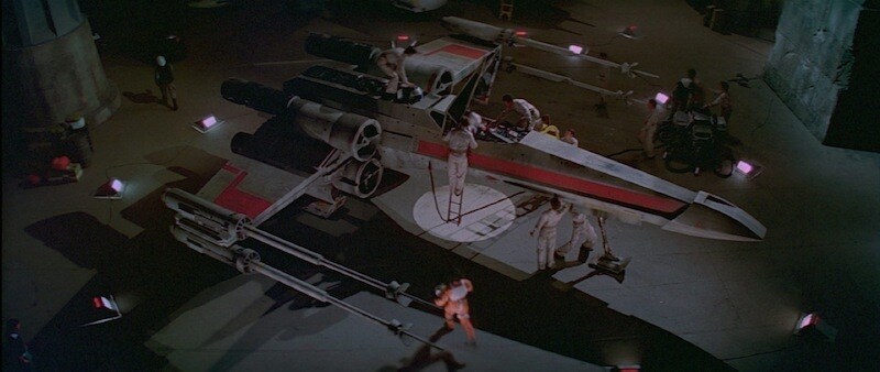 An X-Wing starfighter being prepped for take-off