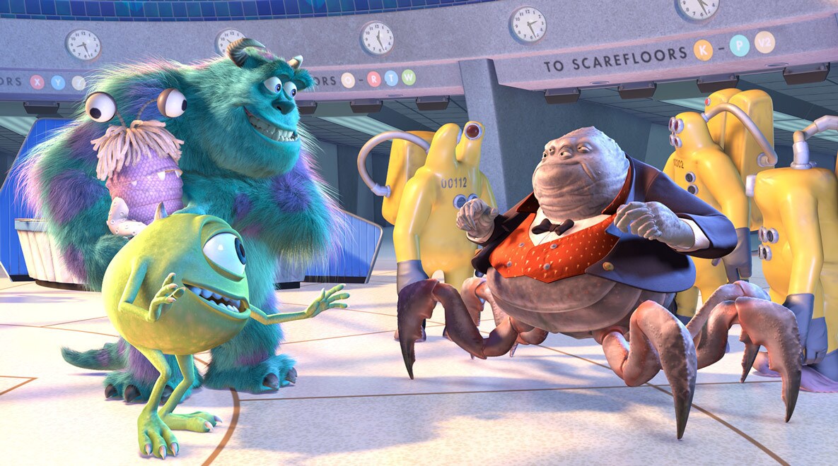 Billy Crystal as Mike Wazowski, John Goodman as Sully holding a costumed Boo, and James Coburn as Mr. Waternoose talking in Monsters, Inc
