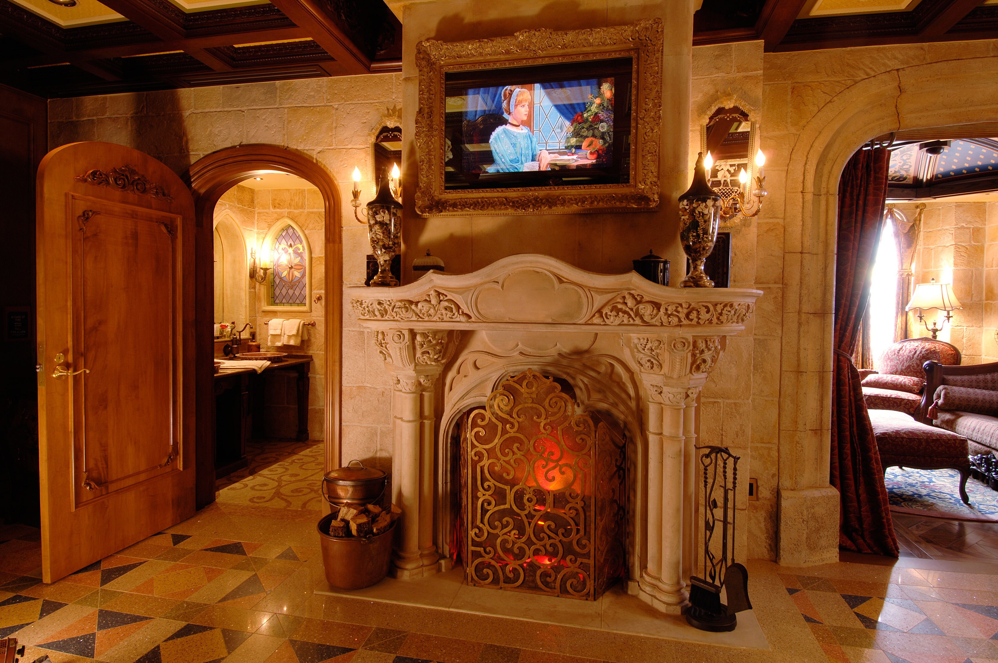 Centerpiece of the Cinderella Castle Suite is an antique limestone fireplace – 17th century Gothi...