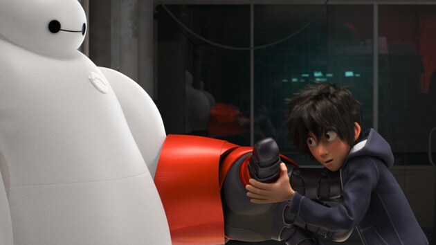 Hiro (voiced by Ryan Potter) holding armored hand of Baymax (voiced by Scott Adsit) in the movie "Big Hero 6"