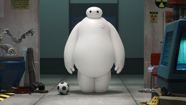 Baymax (voiced by Scott Adsit) standing next to soccer ball in the movie "Big Hero 6"