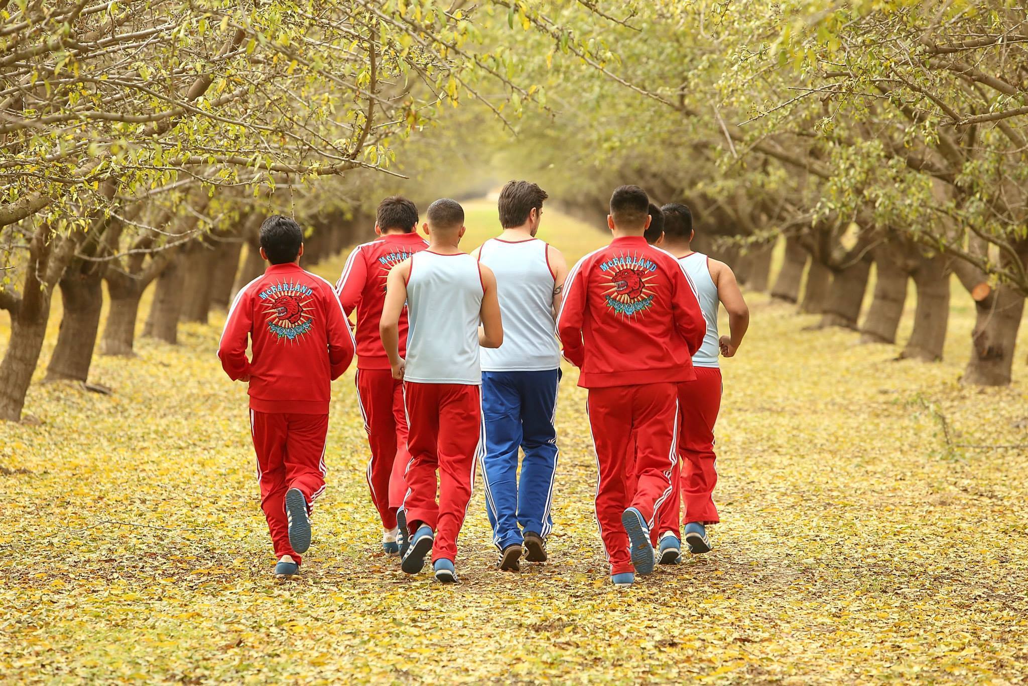 Group of teenagers walking in a field from the movie "McFarland, USA"