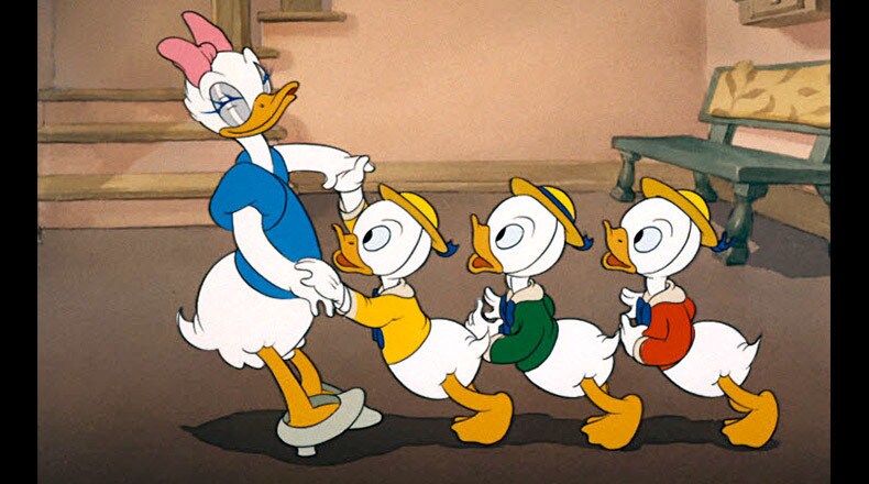 Daisy does a little dancing with Huey, Dewey, and Louie.