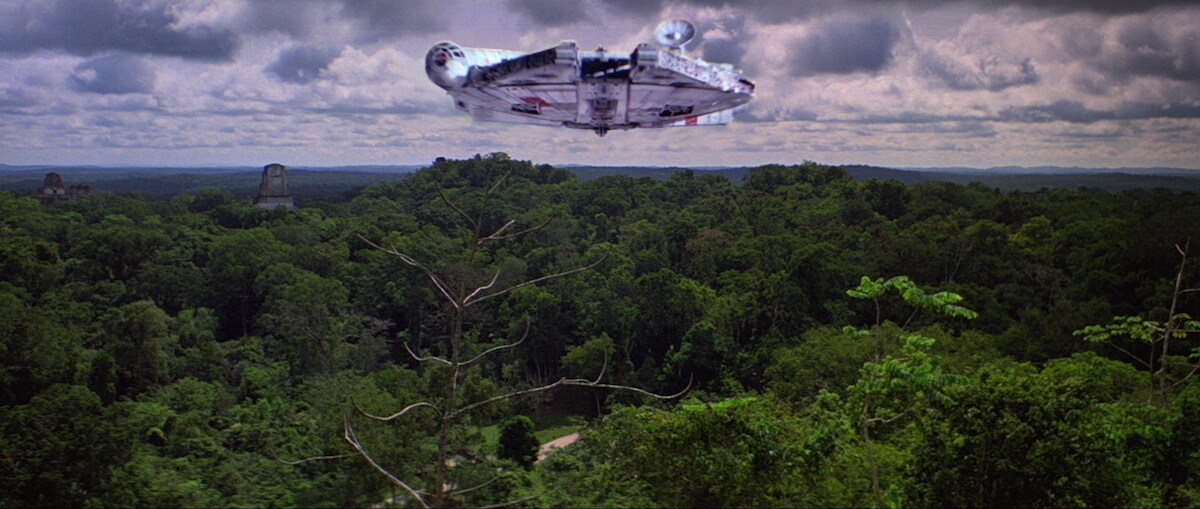 The Millennium Falcon flying over Yavin IV